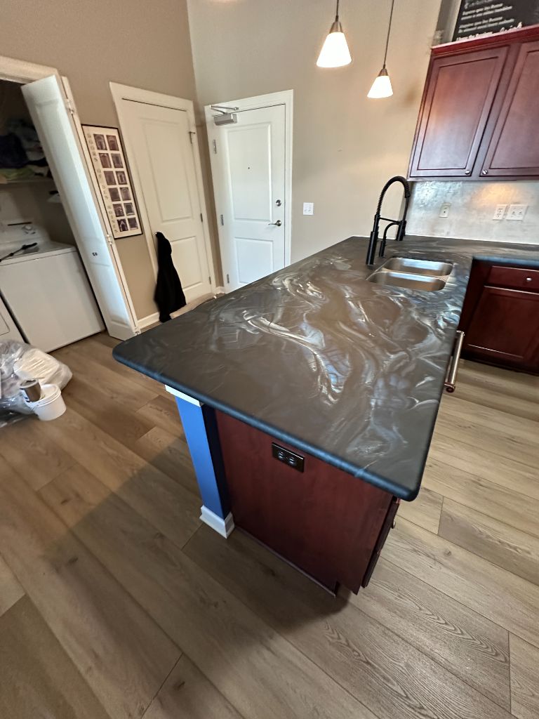 Dark swirl resin stone countertop island transformation Des Moines